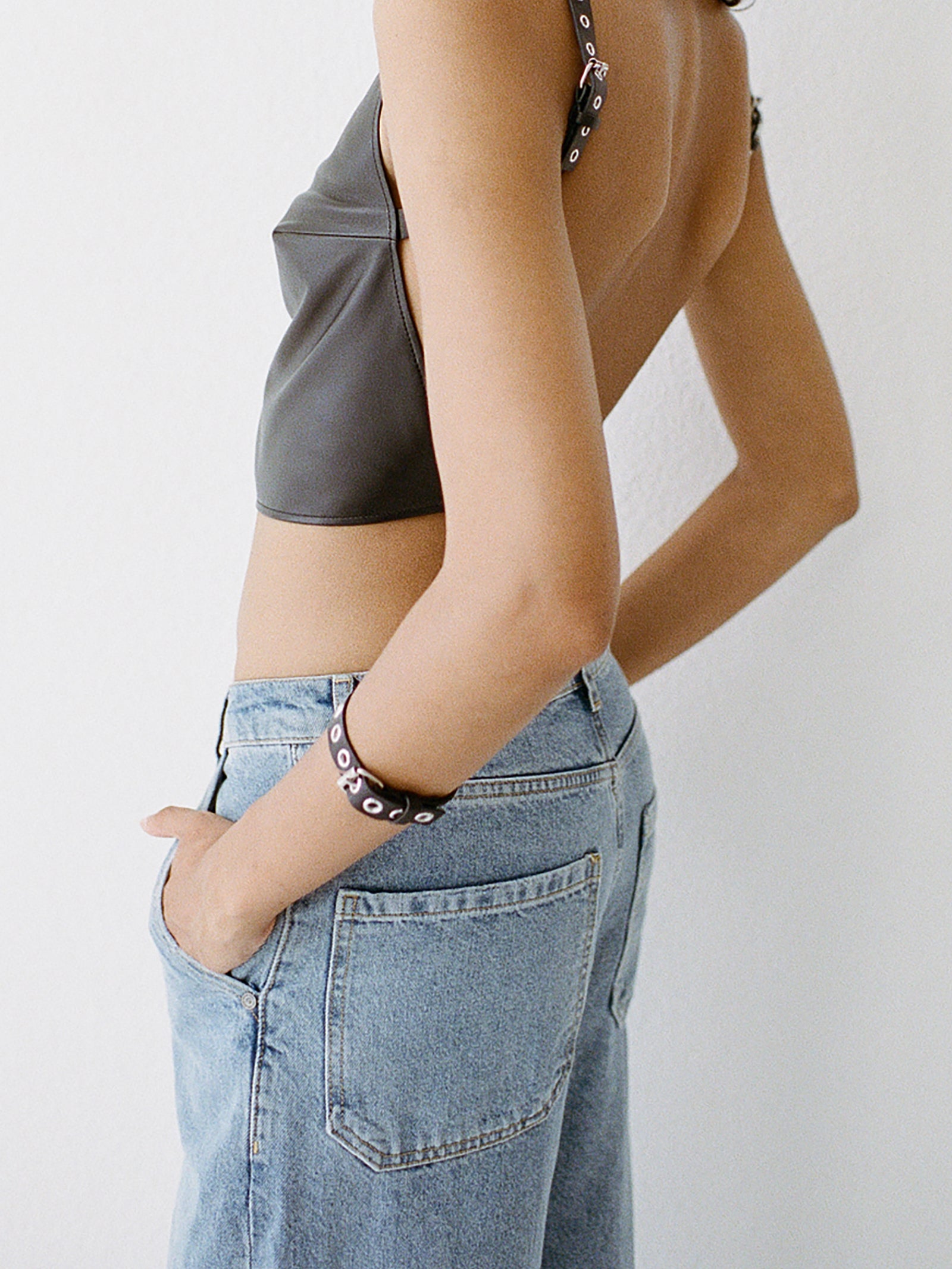 yvy black leather eyelet bracelet wit silver hardware shown on a female model