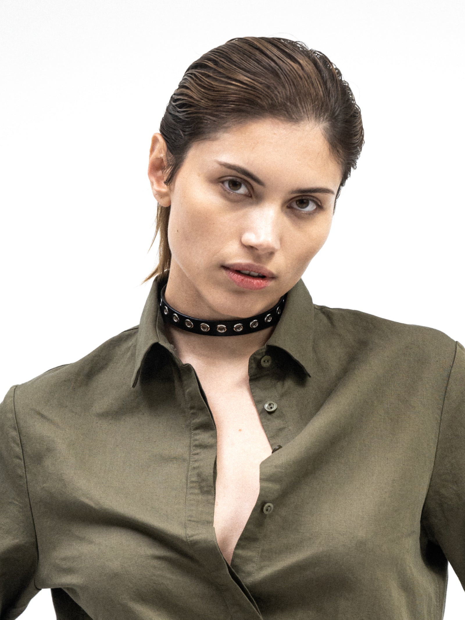 a woman wearing yvy leather eyelet choker 1.6 in black and silver hardware together with green linen shirt