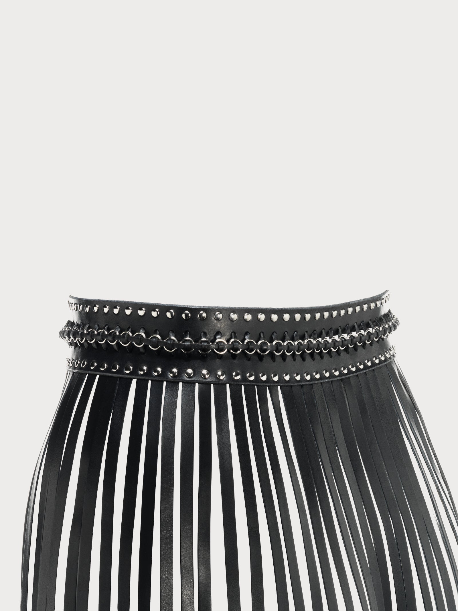 a close-up of a handmade black yvy long fringe belt with silver hardware, showing detailed stiching 
