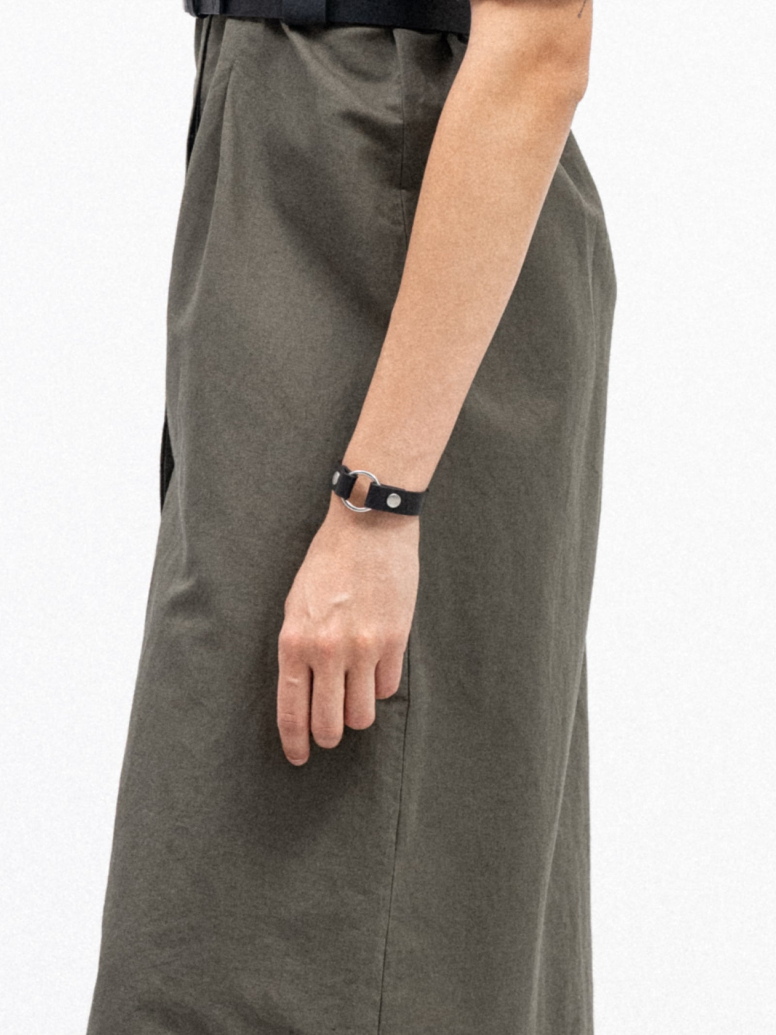 a woman wearing black leather yvy bracelet with ring detail and silver hardware