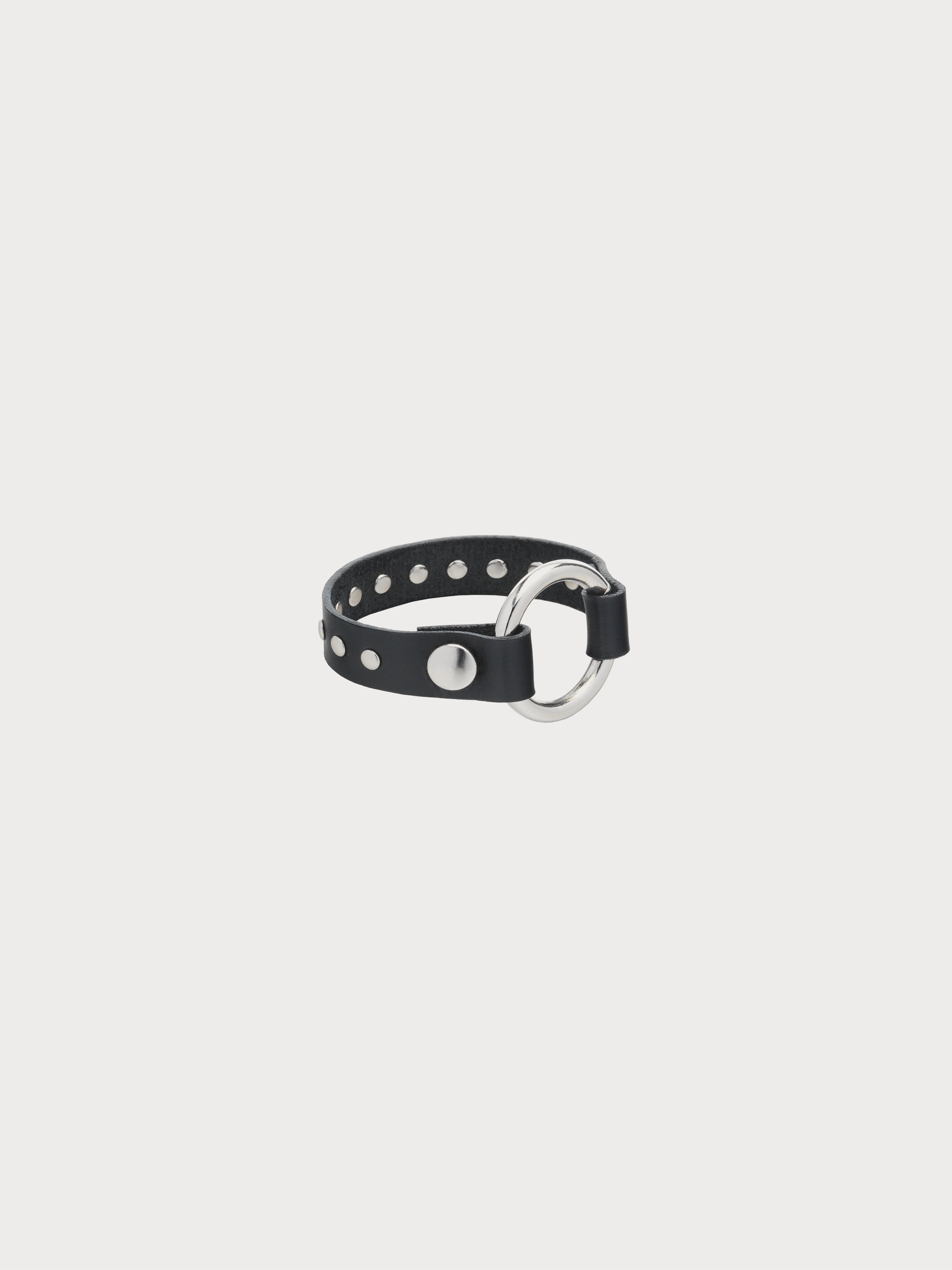 A black leather bracelet with metal rivets and a silver fastening clasp.