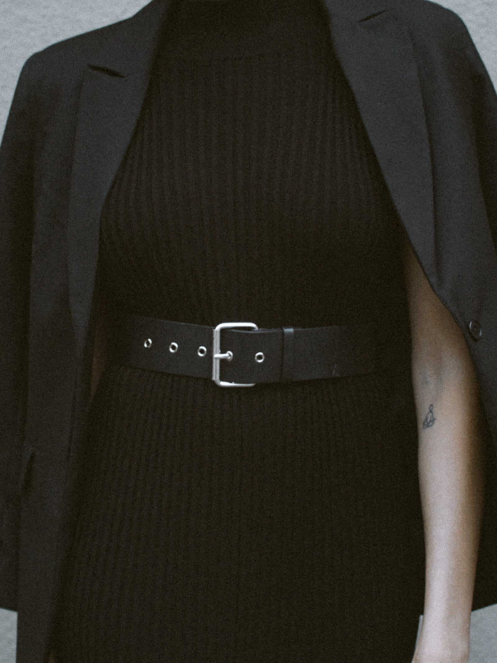 yvy leather wide buckle belt 5 in black with silver hardware on a model wearing it over the black yvy knit dress 
