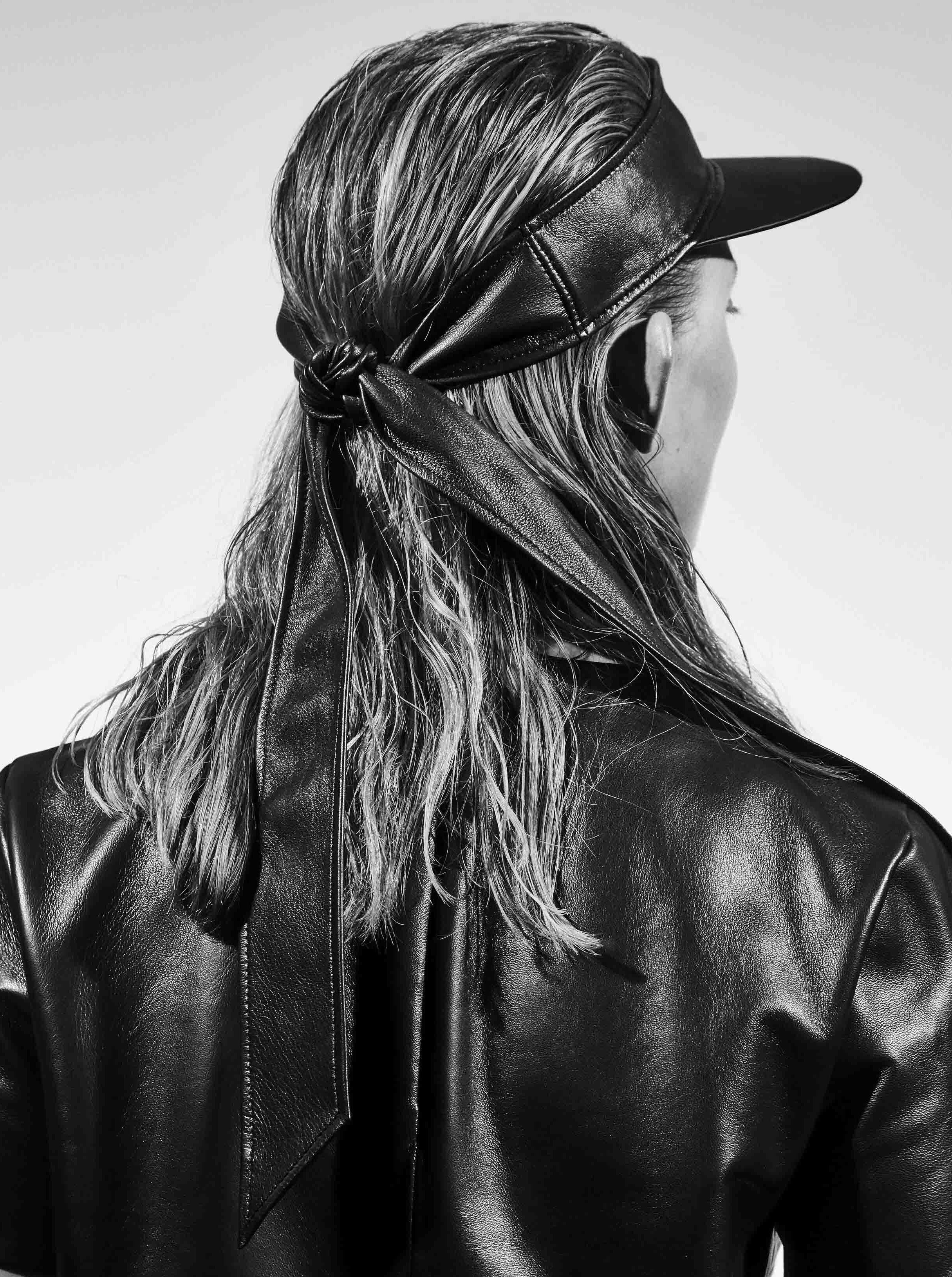 back view of woman wearing yvy leather scarf visor