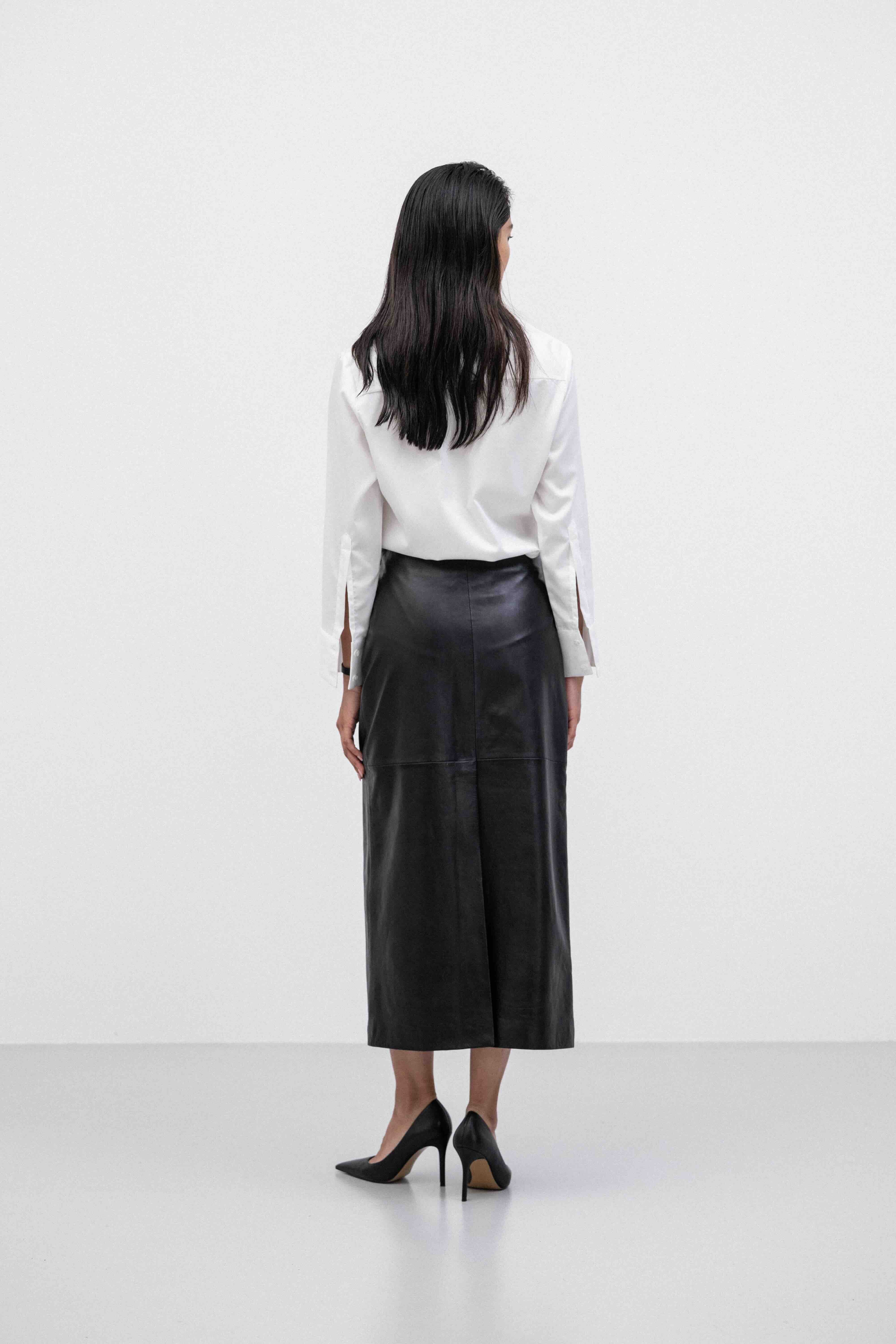 Woman wearing a white shirt and breathable buttery-soft lamb leather straight pencil maxi skirt 
