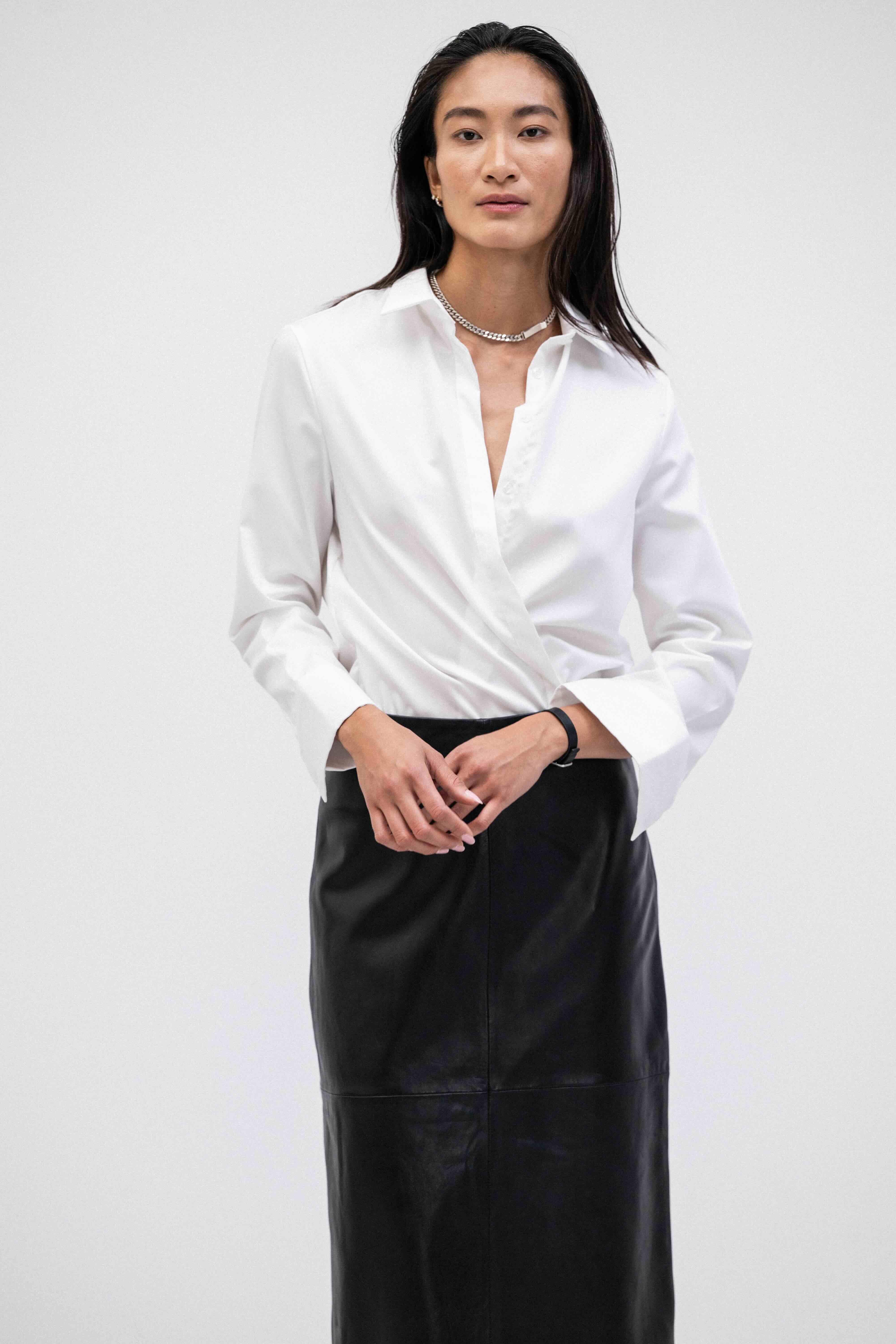 Woman wearing a white shirt and breathable buttery-soft lamb leather straight pencil maxi skirt 