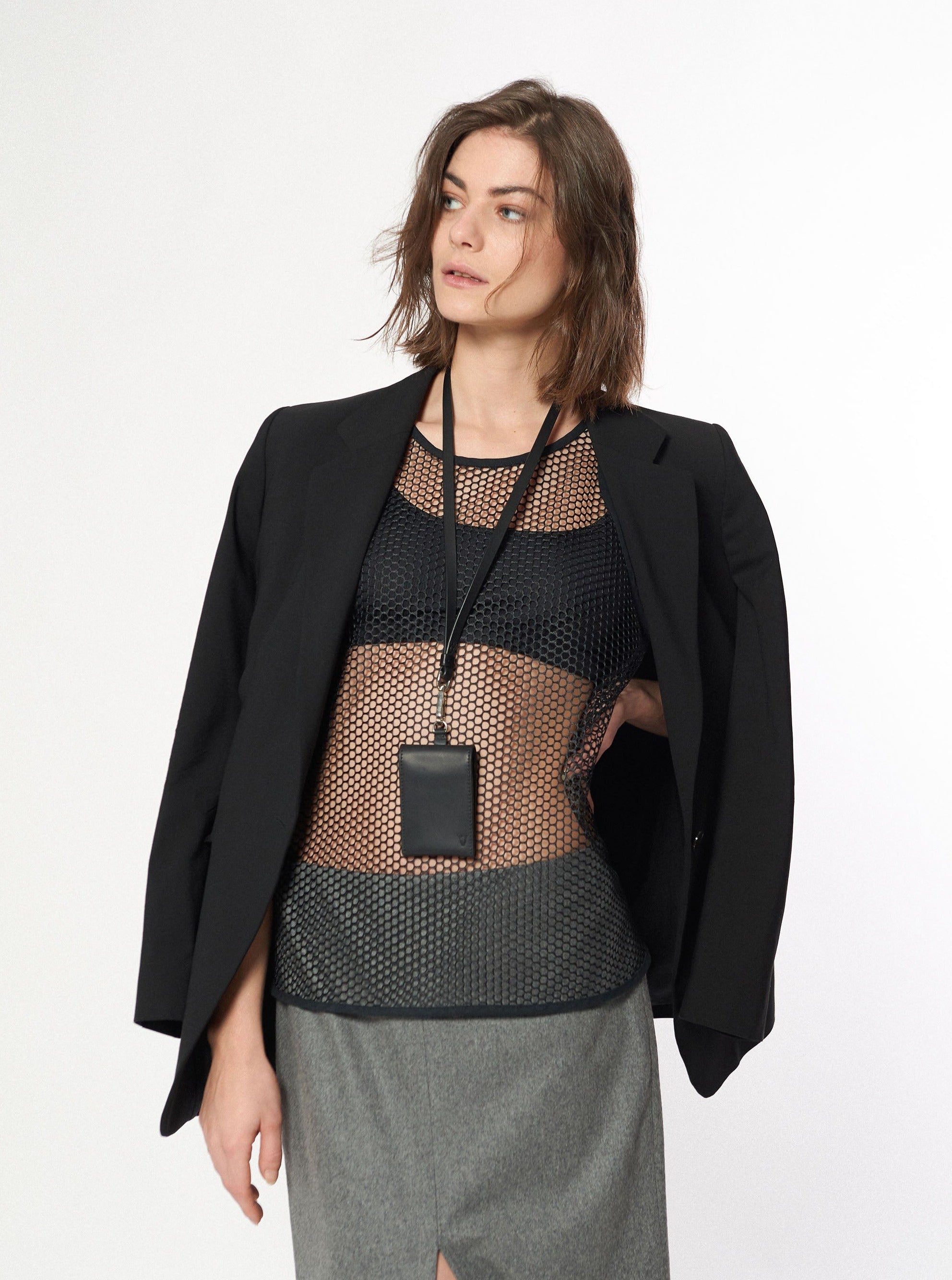 woman wearing yvy leather card wallet over neck with long keychain