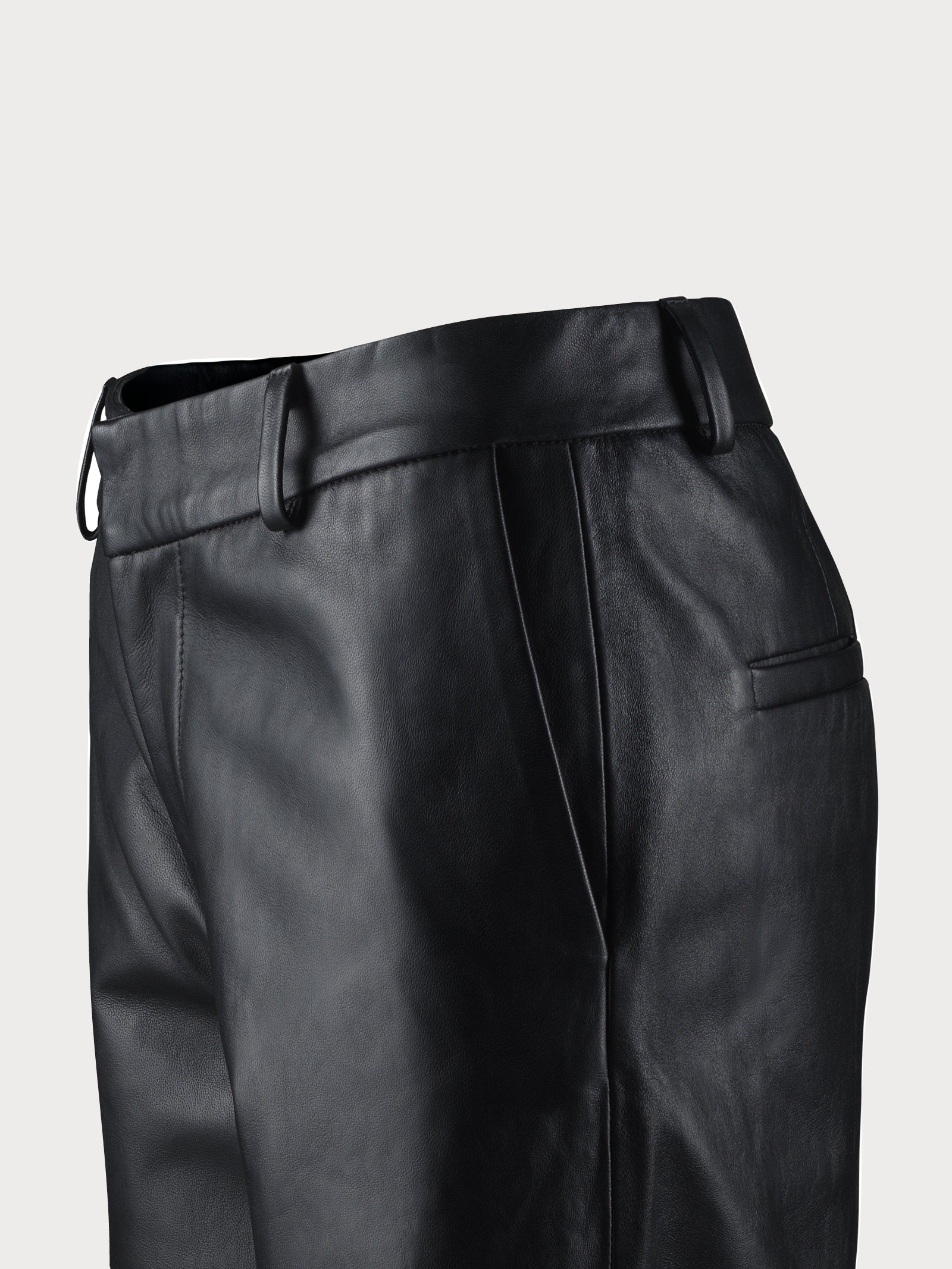 Black leather pants on a light gray background
