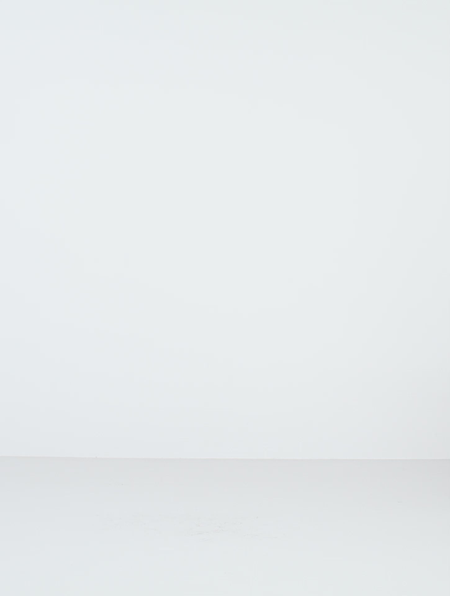 a female model wearing black yvy plisse dress with black yvy moon belt