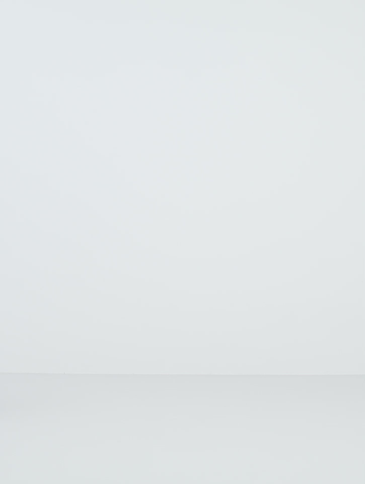 a woman wearing yvy navy blue elegant jumpsuit and black leather yvy eileen bracelet with silver detail