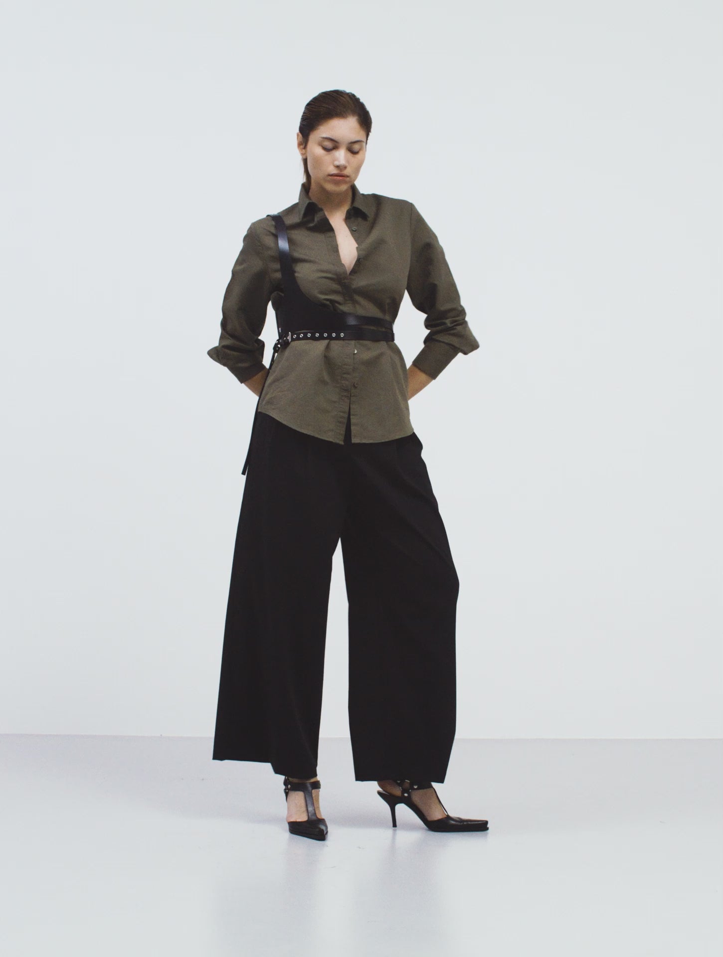 video of a female model wearing the asymmetric wrap body piece in movement