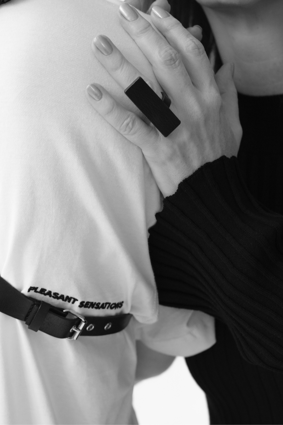 woman hand with black yvy leather ring in rectangle form 