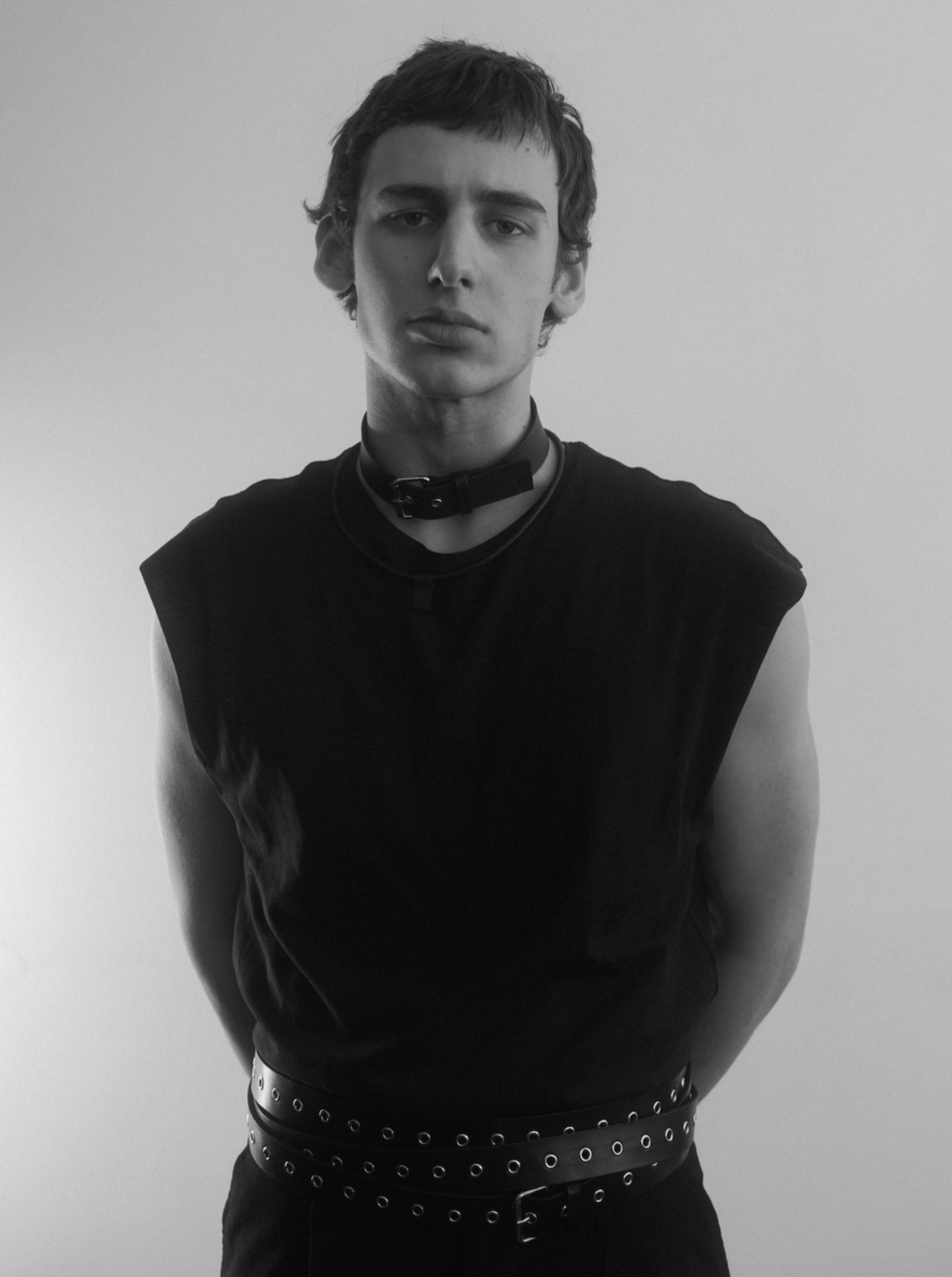 man wearing yvy black leather buckle choker with black tanktop and eyelet belt