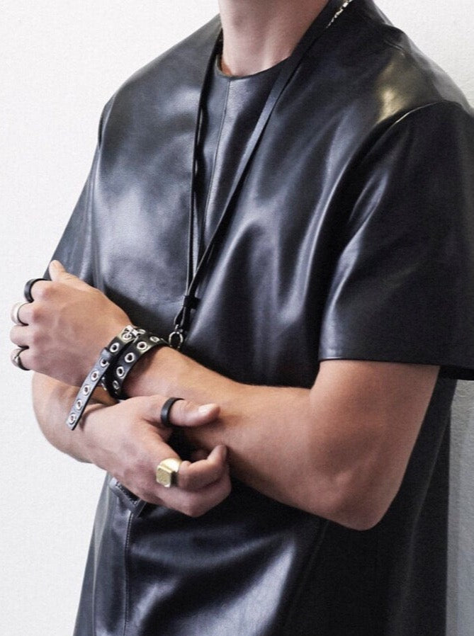 close up of man wearing yvy black leather eyelet choker as a bracelet