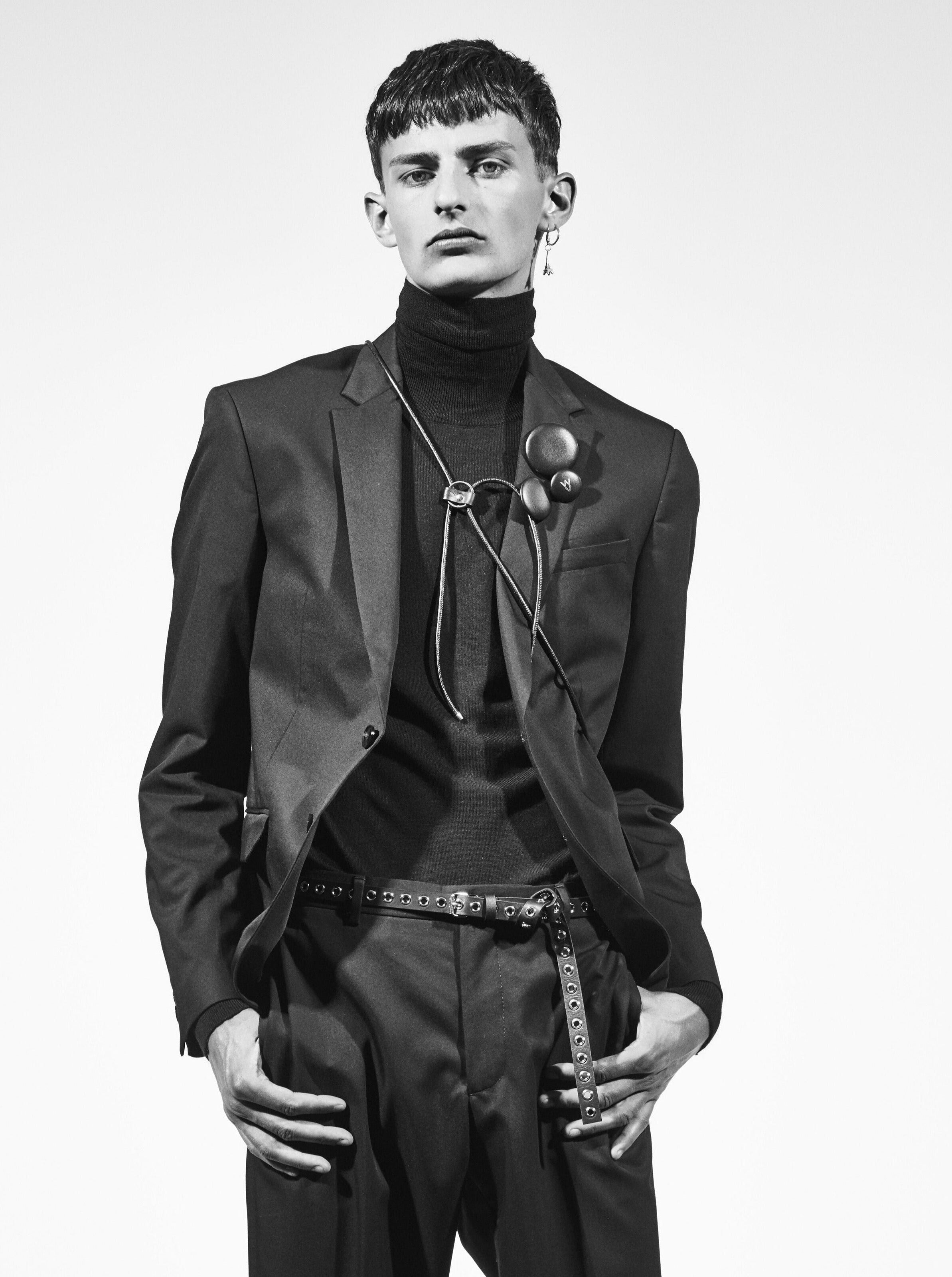 man wearing yvy leather badges on suit jacket lapel